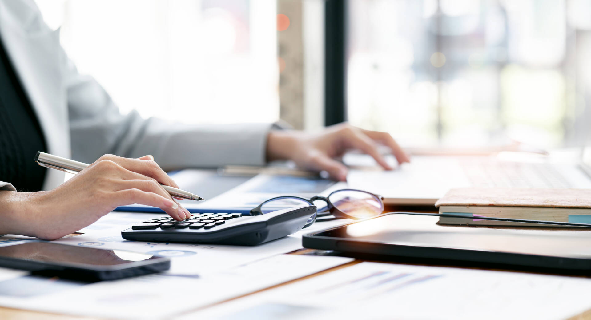 Businesswoman working at office with documents on her desk, doin